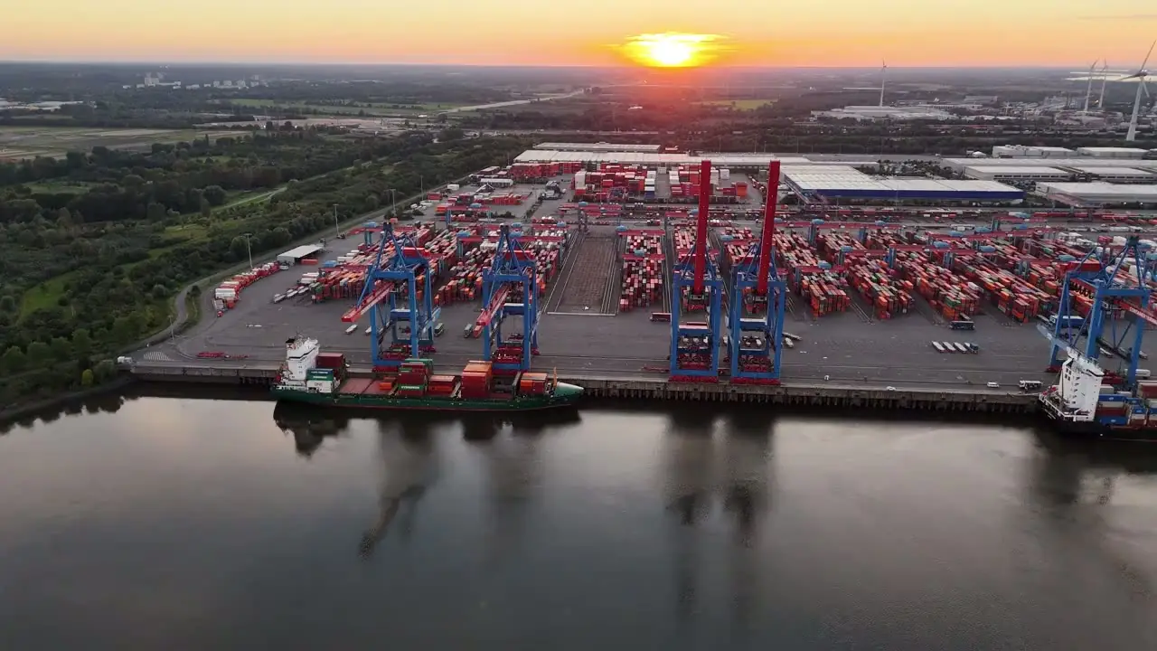 International harbor city and cargo terminal at sunset